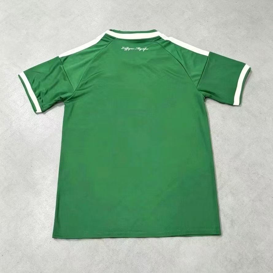 Back view of a green football jersey with white shoulder stripes and sleeve trim