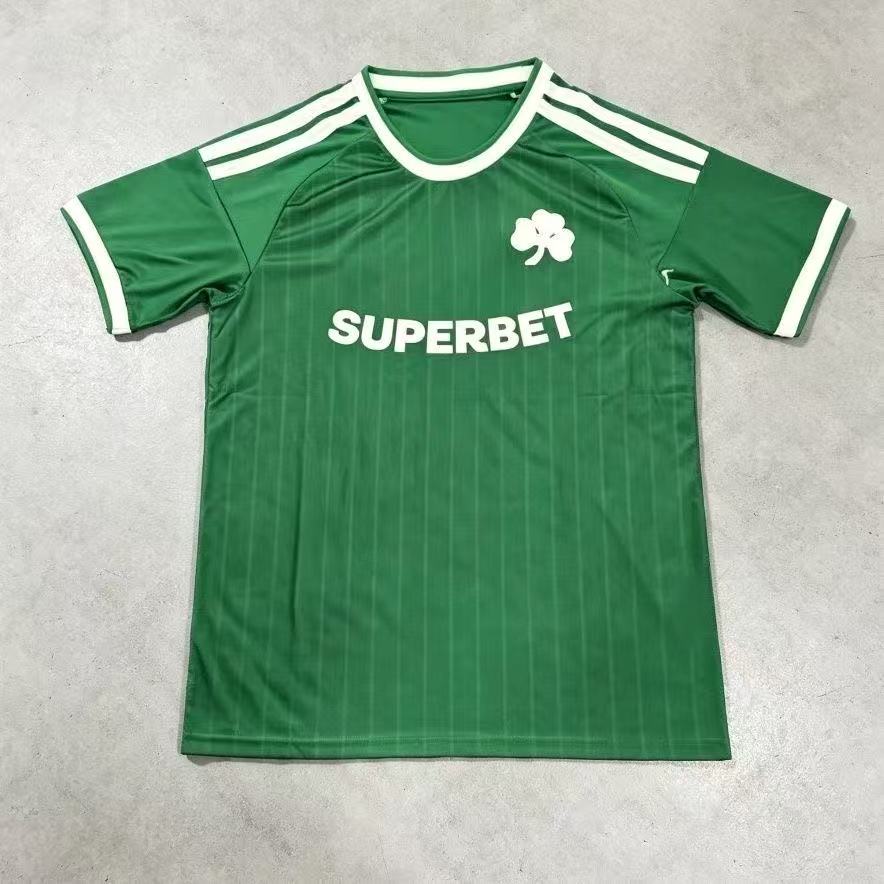 Front view of a green and white short-sleeve football jersey with a shamrock-style crest